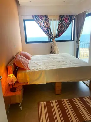 a large bed in a room with a window at Kyaala Suítes - pool & sea view in Praia