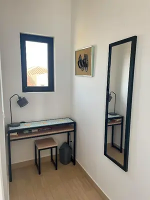 a dressing table with a mirror and a stool at New Rooftop Gem with stunning Oceanview in Santa Maria
