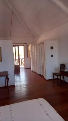 a large room with white walls and a wooden floor at Casa Azul in Mindelo