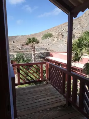 a wooden porch with a view of the desert at Casa Azul in Mindelo