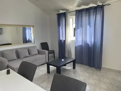 a living room with a couch and a table at Apartamento T2-Dunas Centro in Tarrafal