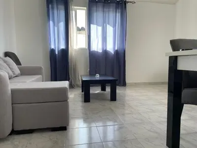 a living room with a couch and a table at Apartamento T2-Dunas Centro in Tarrafal