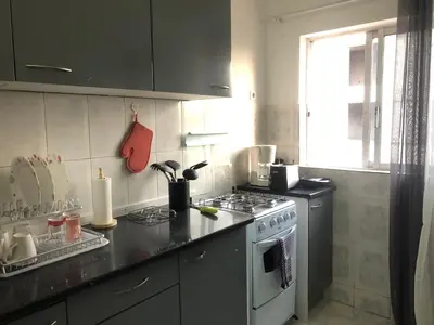 a kitchen with a stove and a counter top at Apartamento T2-Dunas Centro in Tarrafal
