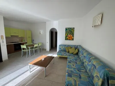a living room with a couch and a table at Holiday Properties Moradias Green in Santa Maria