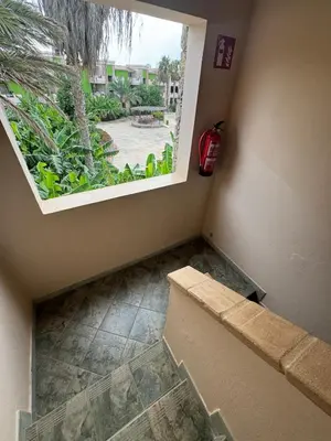 an empty room with a window and a staircase at Holiday Properties Moradias Green in Santa Maria
