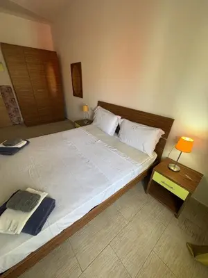 a bedroom with a large bed with white sheets and pillows at Holiday Properties Moradias Green in Santa Maria
