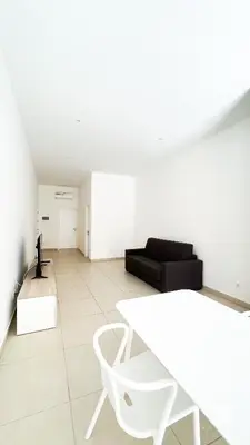 a white living room with a white table and a black couch at Ka Djula in Sal Rei