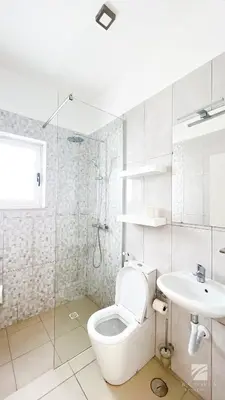 a white bathroom with a toilet and a sink at Ka Djula in Sal Rei