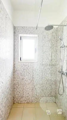 a bathroom with a shower and a window at Ka Djula in Sal Rei