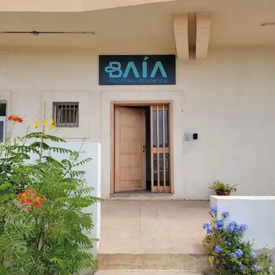 a building with a buna sign on the door at Baia Palmeira Residence in Palmeira