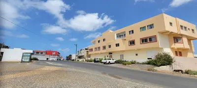 an empty street in front of a building at Baia Palmeira Residence in Palmeira