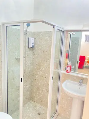 a bathroom with a shower and a sink at Best Rooms- Quarto 4 Plateau in Praia