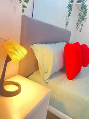 a room with a bed with a lamp and a table at Best Rooms - Quarto 3 Plateau in Praia