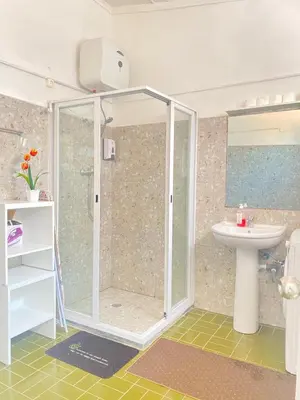 a bathroom with a shower and a sink at Best Rooms - Quarto 3 Plateau in Praia