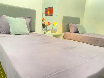 two beds sitting next to each other in a room at Best Rooms- Quarto 2 Plateau in Praia