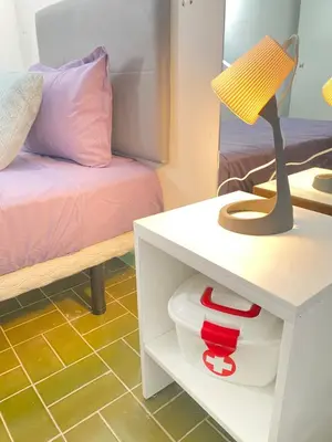 a room with a bed and a table with a lamp at Best Rooms- Quarto 2 Plateau in Praia