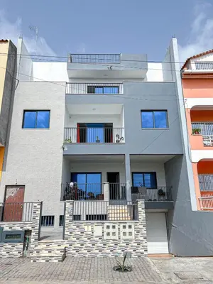 a large white building with balconies on it at Figo Apartamentos Cidadela Comfort Flats in Praia