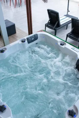a jacuzzi tub with two chairs in a room at Santa Cruz Boutique Hotel in Mindelo