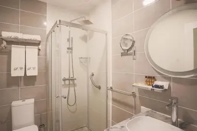 a bathroom with a shower and a toilet and a sink at Santa Cruz Boutique Hotel in Mindelo