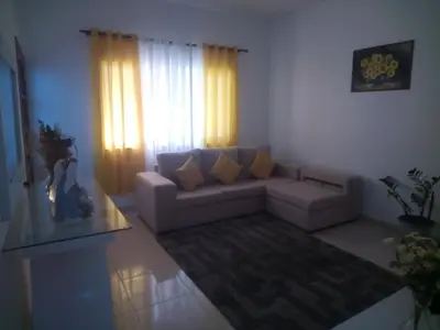 a living room with a couch and a window at Repousando in Mão para Trás