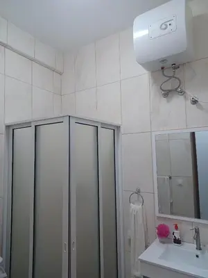 a bathroom with a shower and a sink at Repousando in Mão para Trás
