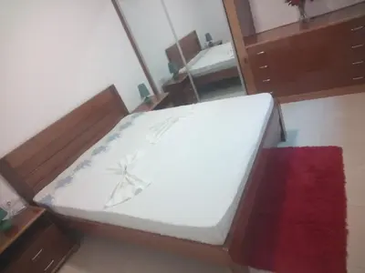 a white bed in a room with a red rug at Repousando in Mão para Trás
