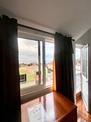 a room with a large window with black curtains at Casa BB&Djassi - ROOMS in Ponta do Sol