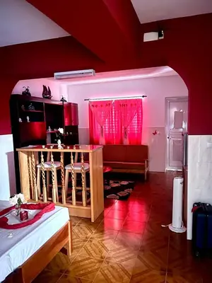 a living room with a couch and a table with red lighting at Casa BB&Djassi - ROOMS in Ponta do Sol