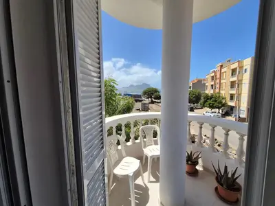 a balcony with chairs and a view of a city at Apart Laginha Tess & To in Mindelo