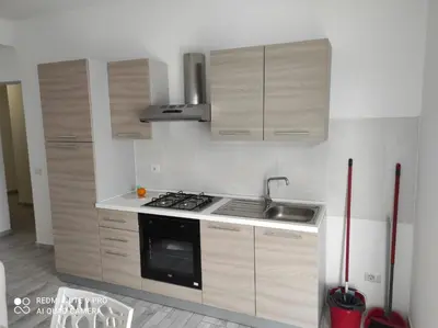 a kitchen with wooden cabinets and a sink and a stove at Casa Veronica Boavista in Sal Rei
