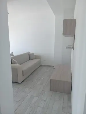 a white living room with a couch and a table at Casa Veronica Boavista in Sal Rei