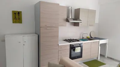 a kitchen with white cabinets and a stove top oven at Casa Veronica Boavista in Sal Rei