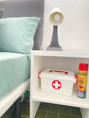 a hospital container on a shelf next to a bed at Best Rooms - Quarto 1 Plateau in Praia