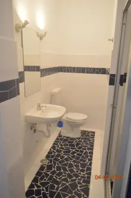 a bathroom with a toilet and a sink at LA VELA in Palmeira
