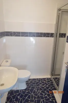 a bathroom with a toilet and a sink at LA VELA in Palmeira