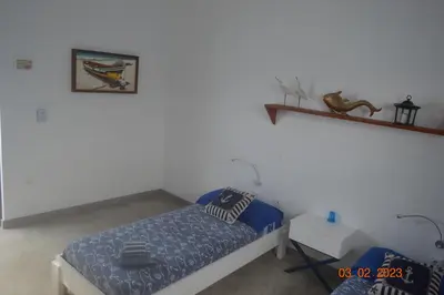 a bedroom with a bed and a shelf on the wall at LA VELA in Palmeira