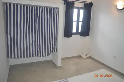 a room with black and white curtains and a window at LA VELA in Palmeira