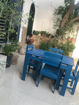a blue table and chairs sitting on a patio at Apartamento t1 mobiliado com Wi-Fi in Praia