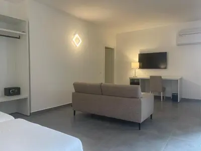 a living room with a couch and a television at Oasis White Hotel in Sal Rei