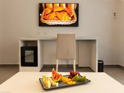 a plate of fruit on a table in a room at Oasis White Hotel in Sal Rei