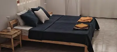 a bedroom with a bed with a blue blanket on it at Maya Apartments in Mindelo