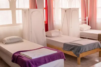 a room with three bunk beds in it at Maya Apartments in Mindelo