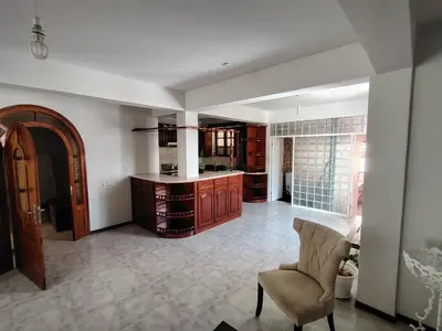 a large kitchen with a table and a chair at Maya Apartments in Mindelo