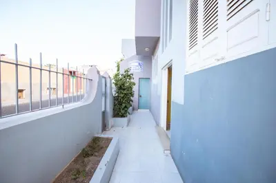 an empty hallway of a building with plants at Maya Apartments in Mindelo