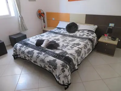 a couple of people laying on a bed at Adult only beachfront 2 bedroom apartment Santa Maria airport pick up, aircon, unlimited wifi ideal for remote working and long stay in Santa Maria
