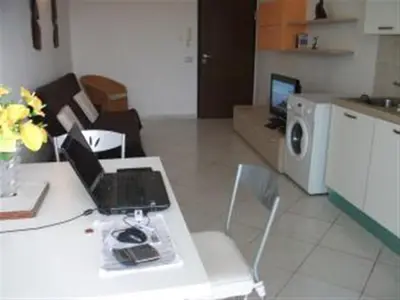 a living room with a table with a laptop on it at Adult only beachfront 2 bedroom apartment Santa Maria airport pick up, aircon, unlimited wifi ideal for remote working and long stay in Santa Maria