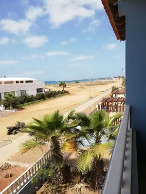 a view from a balcony of a street with palm trees at Adult only beachfront 2 bedroom apartment Santa Maria airport pick up, aircon, unlimited wifi ideal for remote working and long stay in Santa Maria
