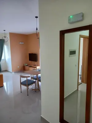 a living room with a table and chairs and a mirror at Nifa House in Espargos