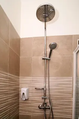 a shower with a shower head in a bathroom at Nifa House in Espargos