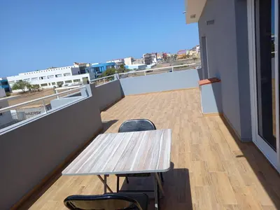 a table and chairs on a balcony with a view at Nifa House in Espargos